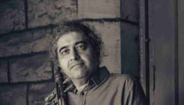 Shahriyar Jamshidi stayed on front of a church for a photoshoot with his Kamancheh Photo Credit: Curtis Perry